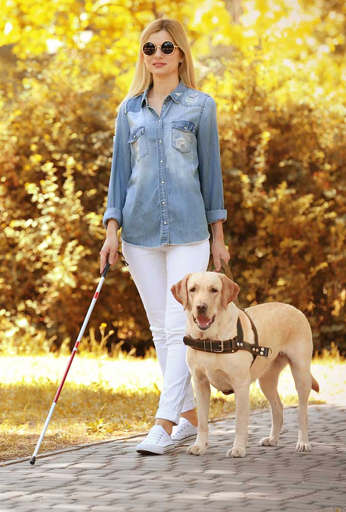 blind woman walking with dog